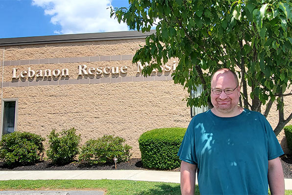 A man smiles outside of the Lebanon Rescue Mission