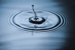 A drop of water creates a ripple.